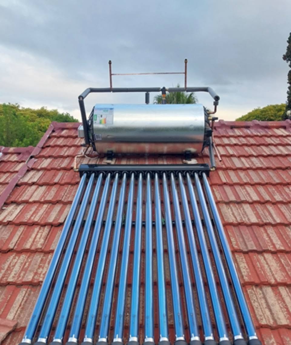 Solar geyser with evacuated tubes on a tiled roof